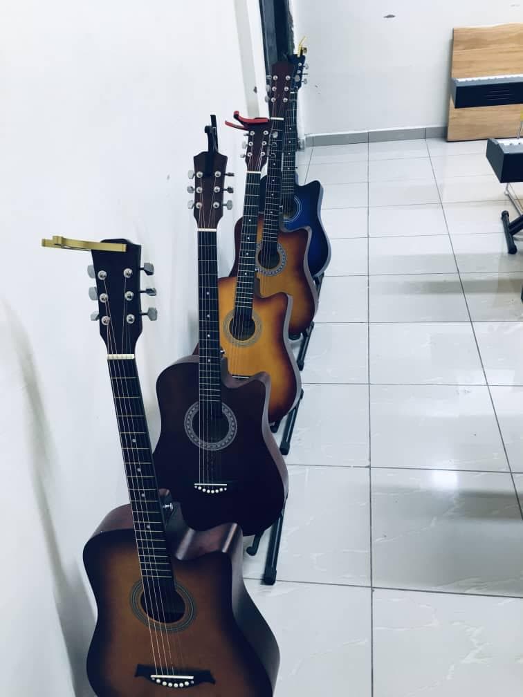 Acoustic guitars lined up in the studio